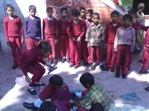 Thanks you! Prof Jay Garfield and Dr Leila Toiviainen - BSS kids wearing new shoes and socks